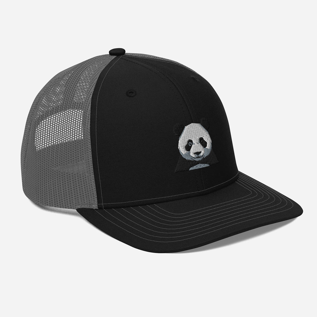Stylio black trucker cap with grey mesh back and embroidered panda face graphic on the front panel.