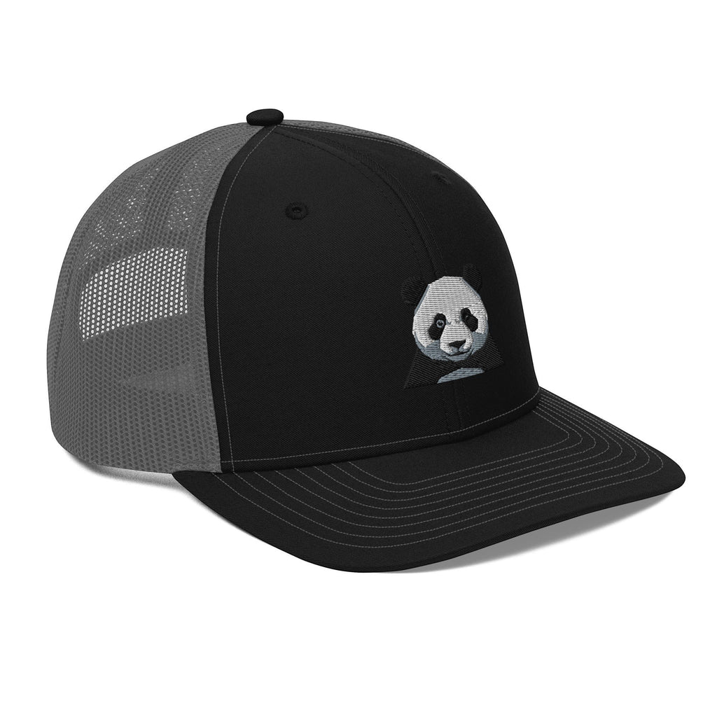 Stylio black trucker cap with grey mesh back and embroidered panda graphic on front panel. Structured fit, curved visor.