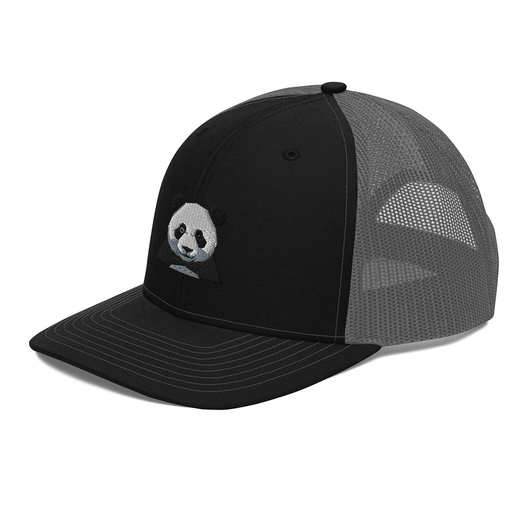Stylio black trucker cap with grey mesh back and embroidered panda graphic on the front panel. Features a curved visor and snapback closure.
