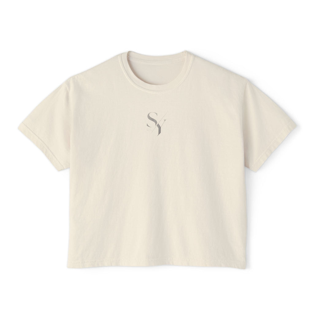 Stylio cream pigment-dyed cotton boxy tee with a subtle grey logo on the chest. Relaxed fit, cropped silhouette.