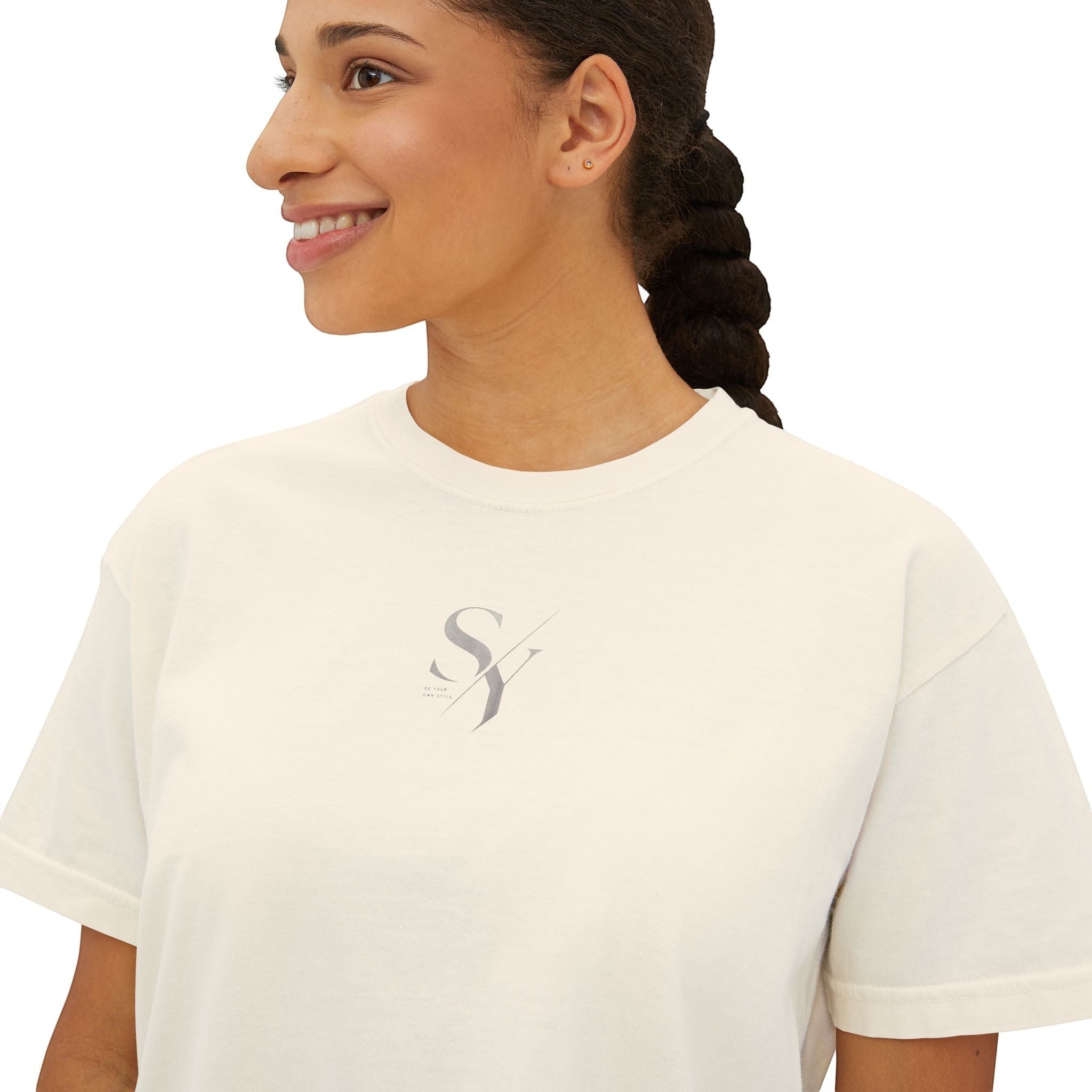 Stylio cream pigment-dyed cotton boxy tee with minimalist grey logo on chest. Relaxed fit, crew neck, short sleeves.