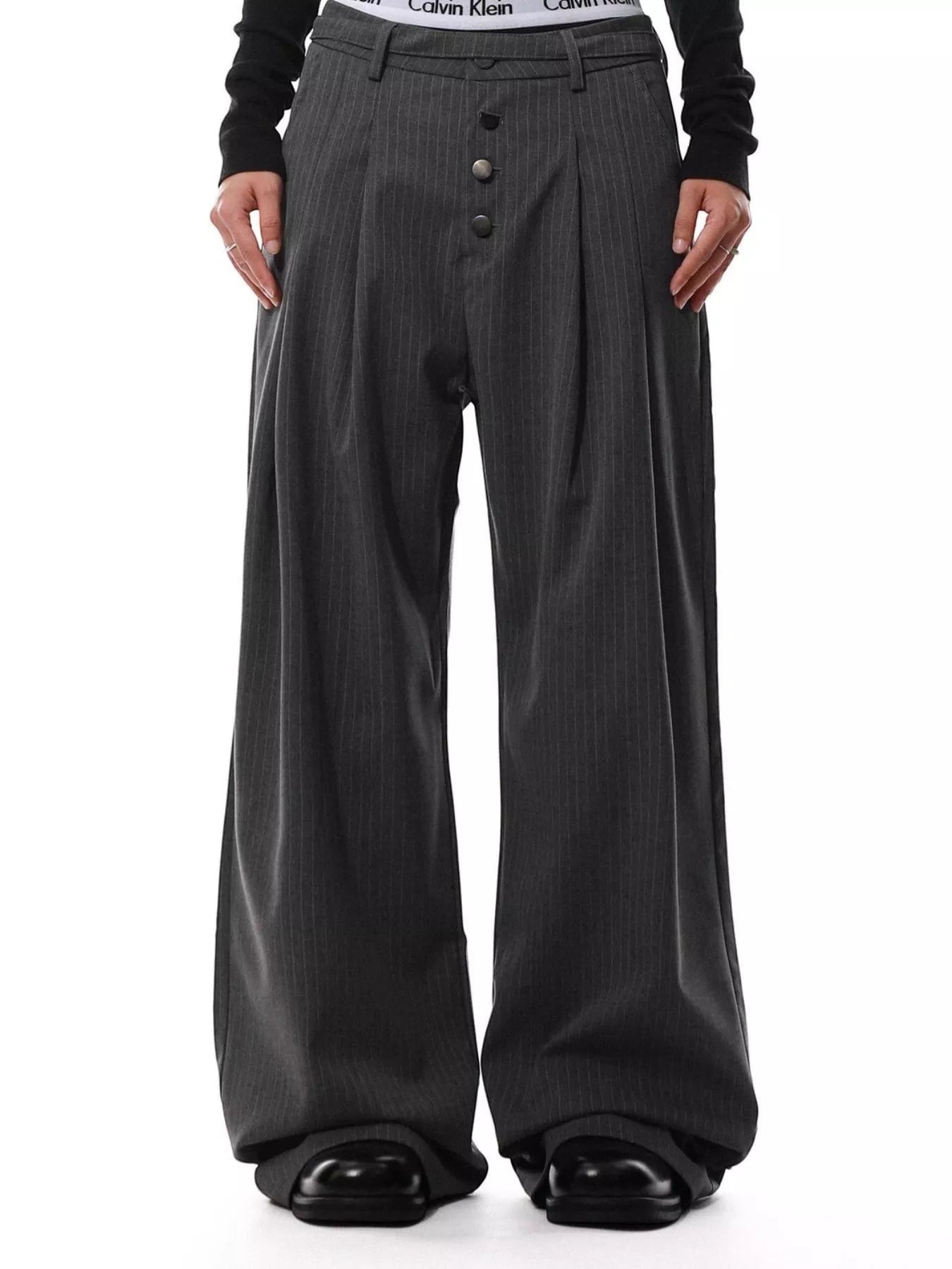 Stylio men's dark grey pinstripe wide-leg pants with button-front closure and pockets. Polyester-spandex blend.