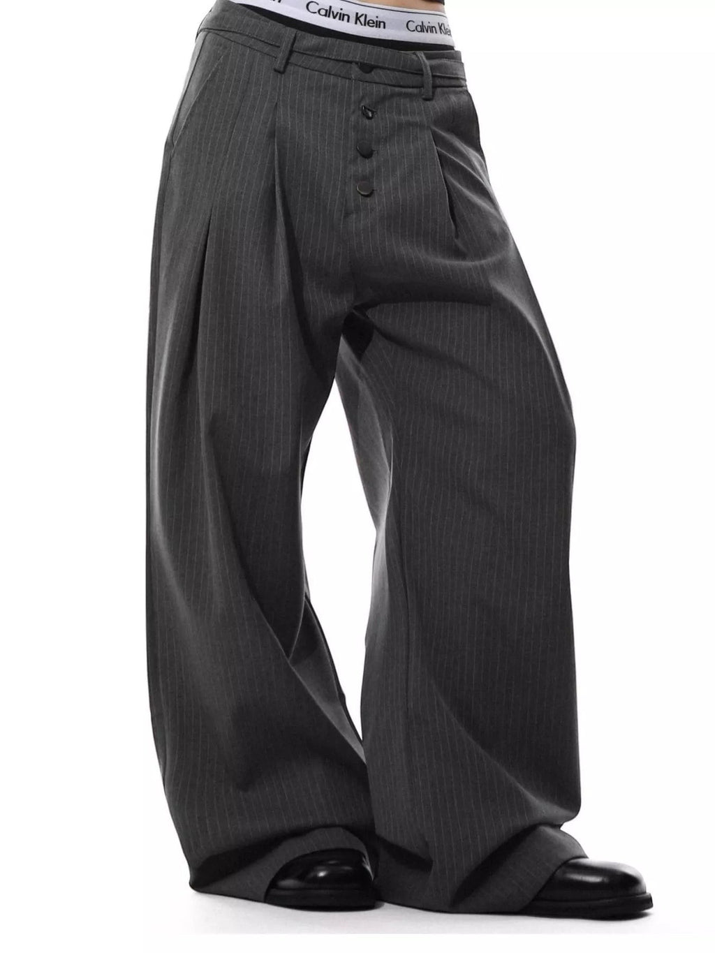Stylio men's dark grey pinstripe wide-leg pants with button-front closure and pockets. Polyester-spandex blend.