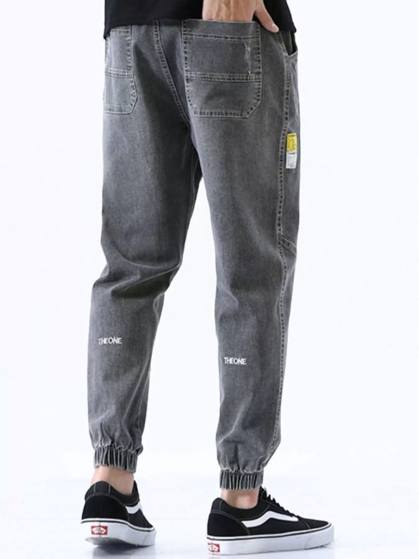 Stylio men's grey washed cotton loose fit drawstring jeans with elastic cuffs and pockets.