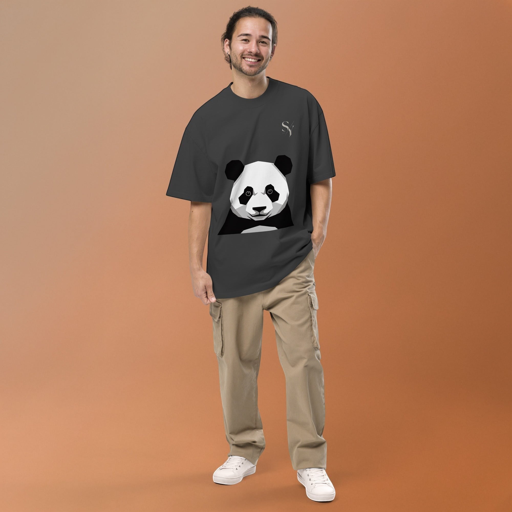 Stylio oversized charcoal t-shirt with a graphic panda print and dropped shoulders. Model wears it with khaki cargo pants.