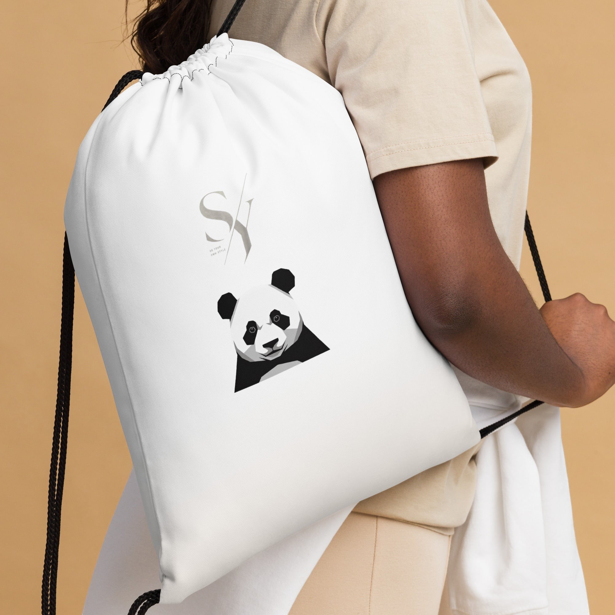 Stylio white polyester drawstring bag with a geometric panda graphic and logo, worn by a person.