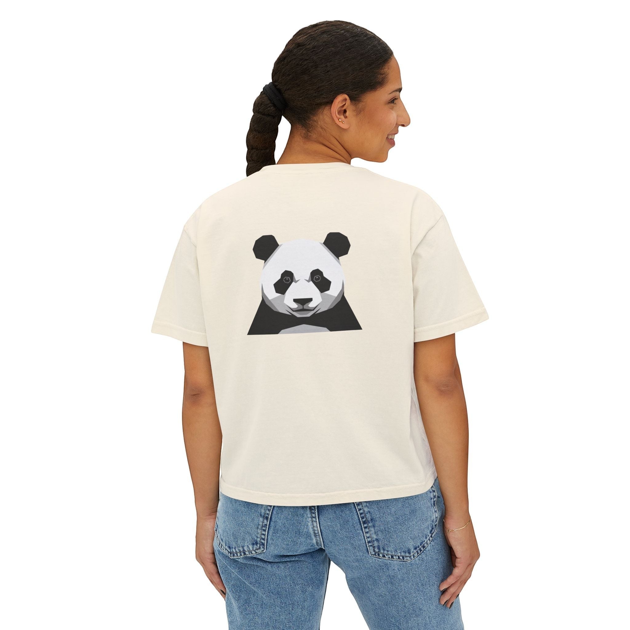 Stylio cream pigment-dyed cotton boxy tee with a minimalist panda graphic on the back. Model wears jeans.