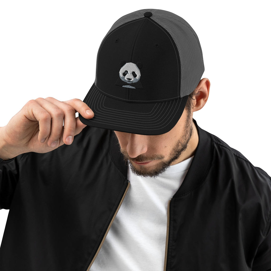 Stylio black trucker cap with grey mesh back and embroidered panda graphic. Adjustable snapback closure.