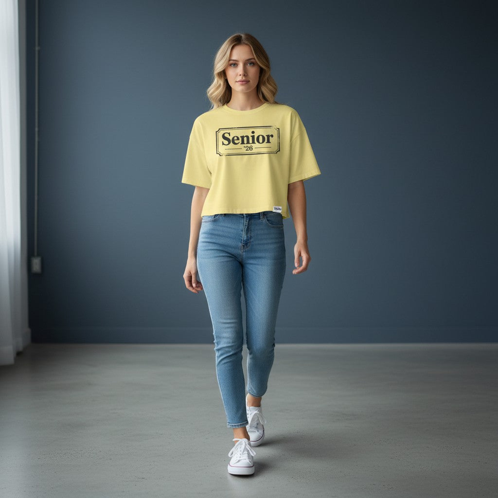 Stylio Women's pale yellow crop tee with "Senior '26" graphic print. 100% cotton, relaxed fit.