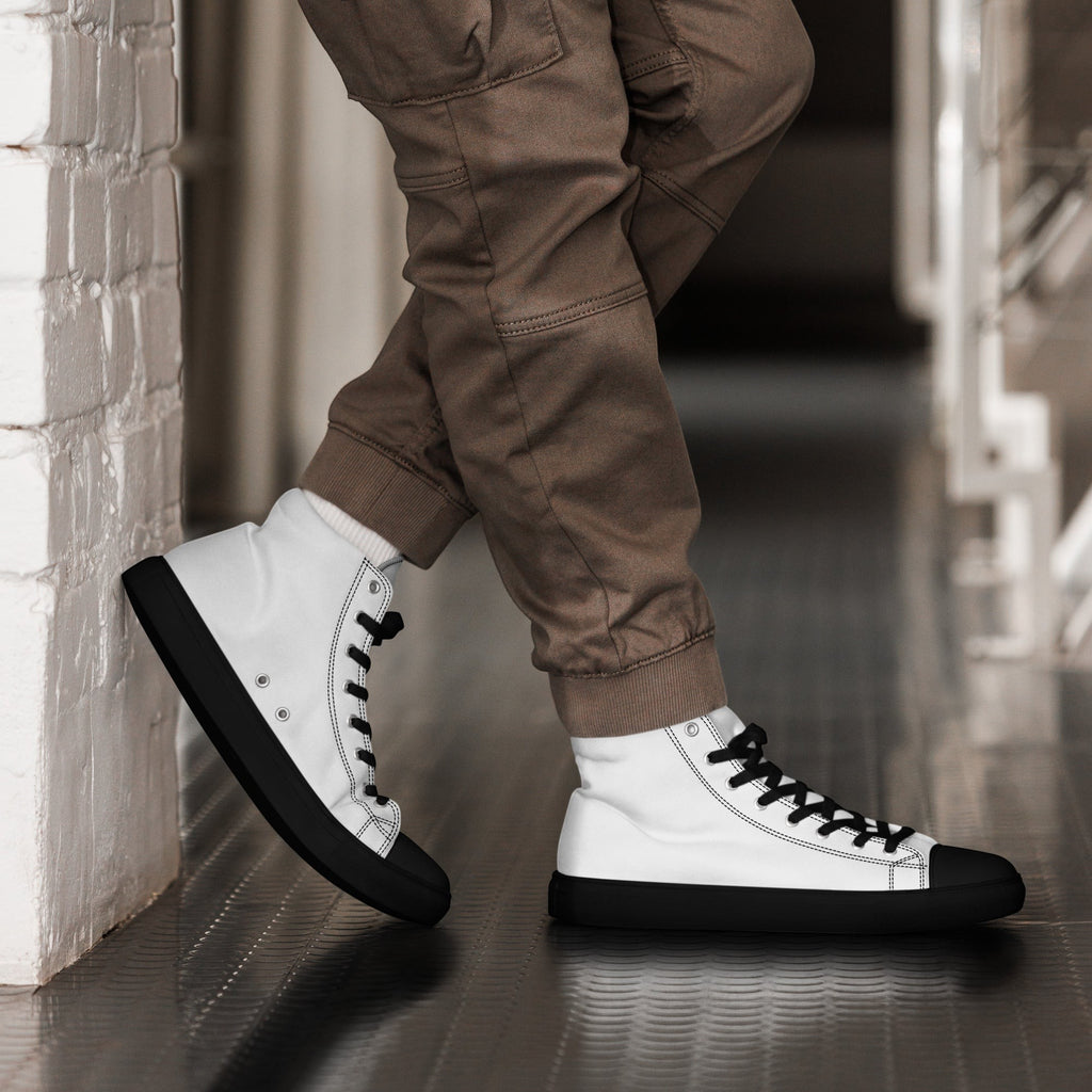 Stylio men's white canvas high top shoes with black laces, soles, and toe caps, worn with brown cargo pants.