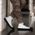 Stylio men's white canvas high top shoes with black laces, soles, and toe caps, worn with brown cargo pants.