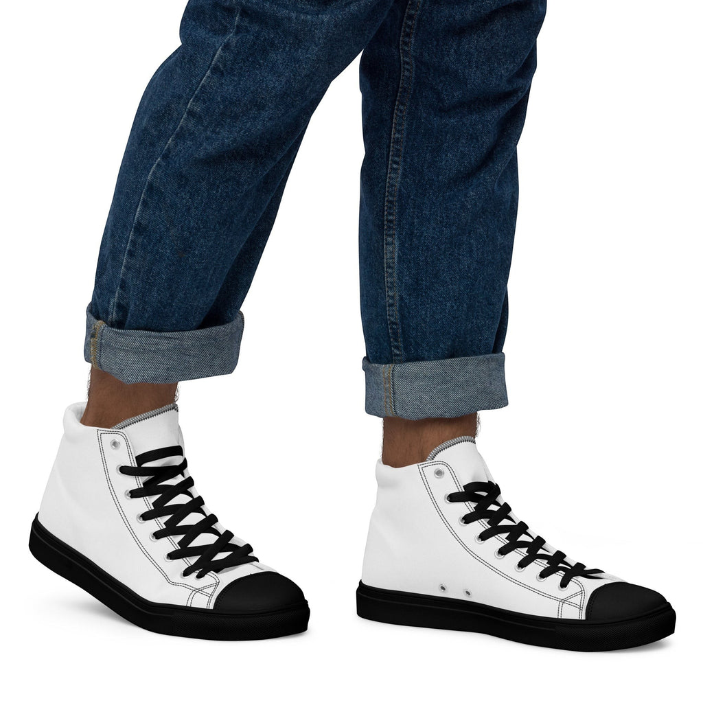 Stylio men's white canvas high top sneakers with black laces, black toe cap, and black sole. Worn with cuffed blue jeans.