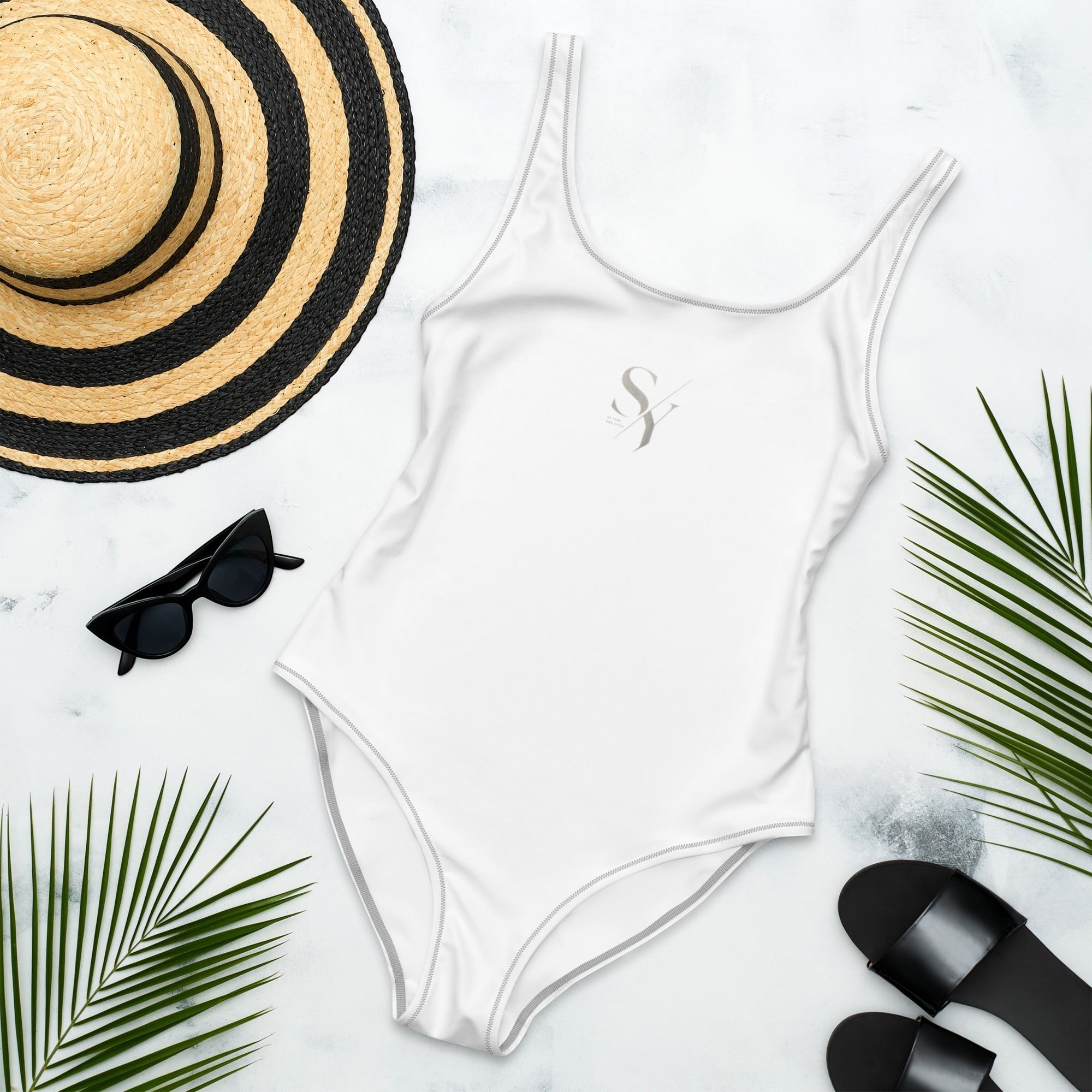 Stylio white one-piece swimsuit with scoop neckline and low scoop back, made from recycled polyester and elastane.