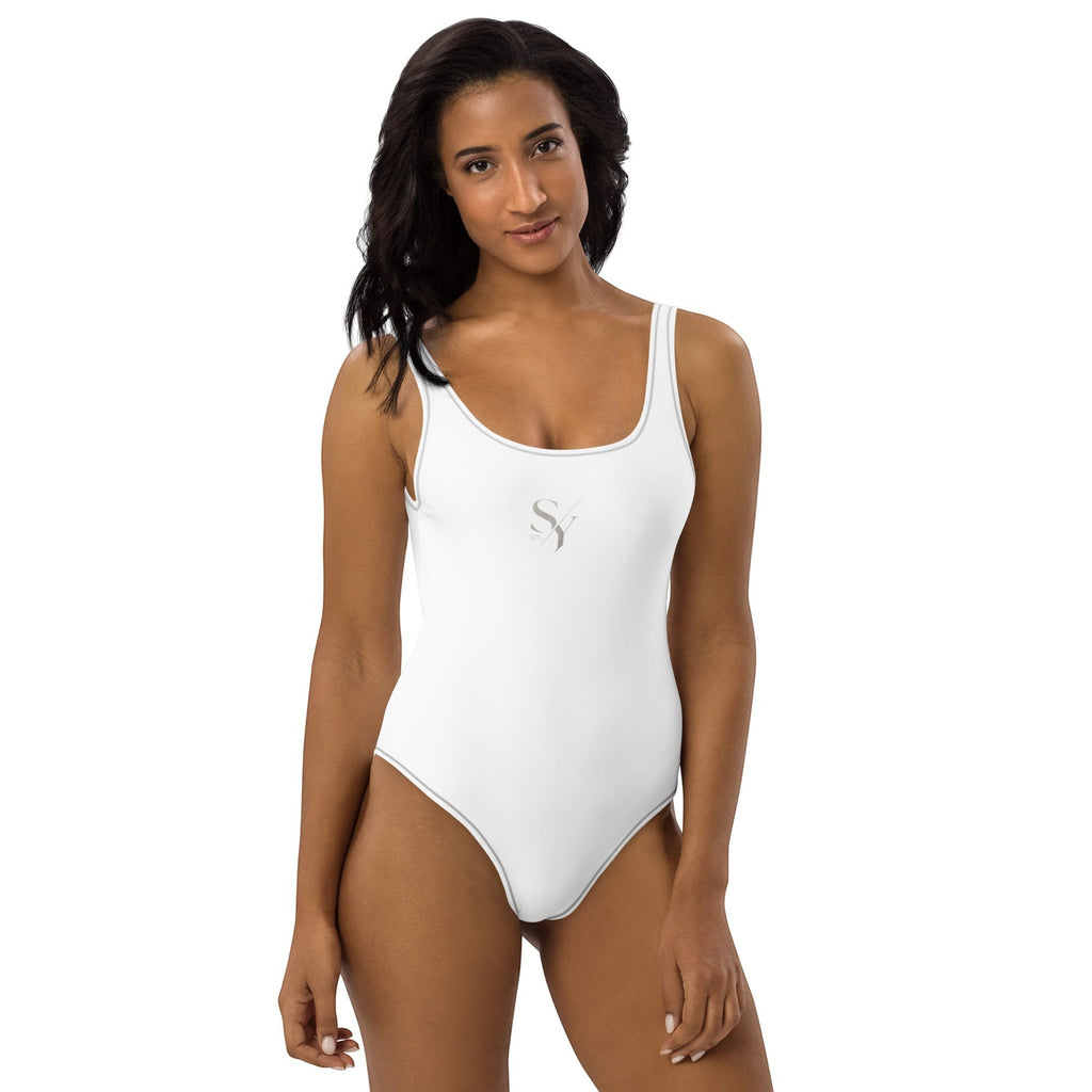 Stylio white one-piece swimsuit with scoop neckline, low scoop back, and cheeky fit. Made from recycled polyester and elastane.