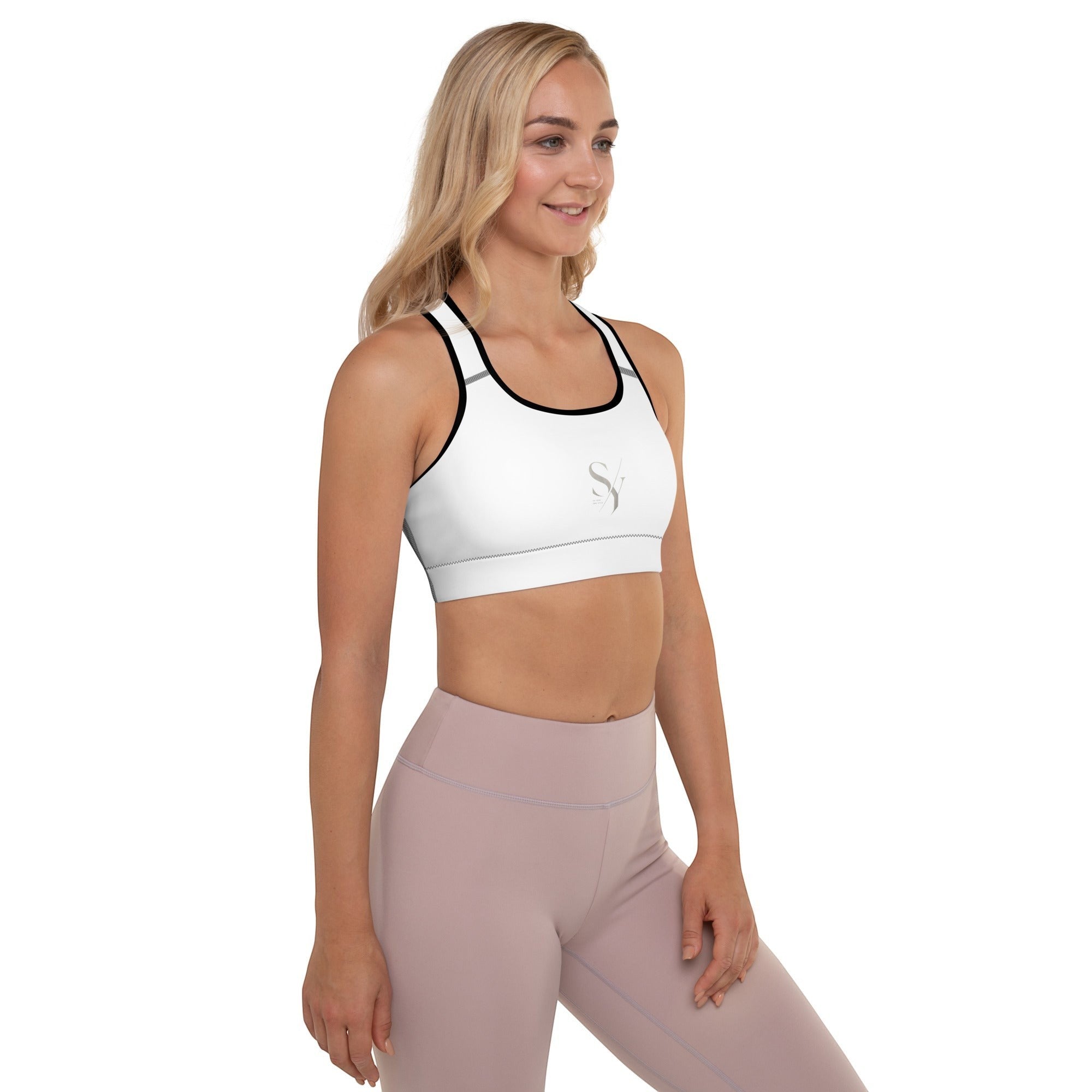 Stylio white padded sports bra with black trim, racerback, and removable padding. Moisture-wicking fabric for maximum support.