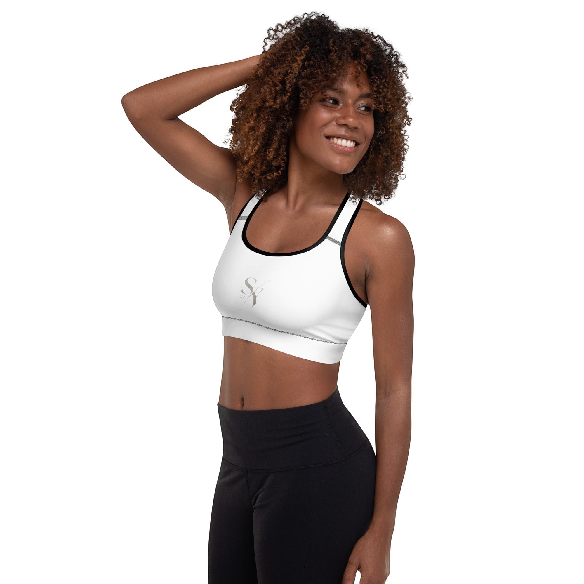 Stylio white padded sports bra with black trim, scoop neck, racerback, and removable padding for A-C cups.