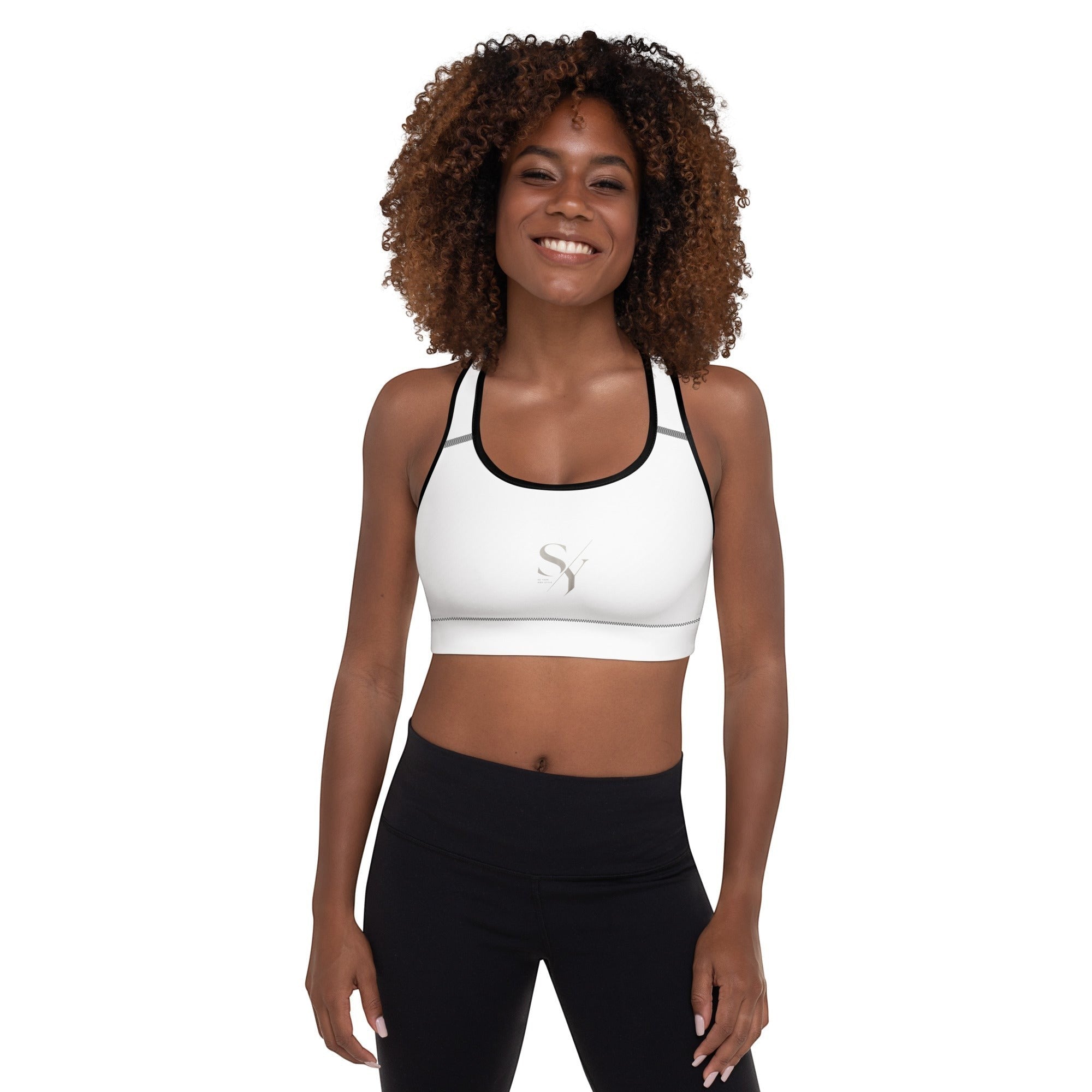 Stylio white padded sports bra with scoop neckline, racerback, and removable padding. Moisture-wicking fabric.