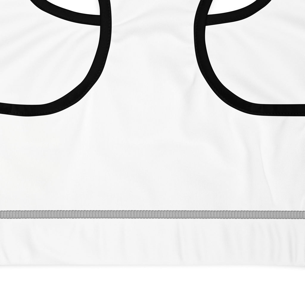 Stylio white padded sports bra with black trim and racerback design. Moisture-wicking fabric with removable padding for support.