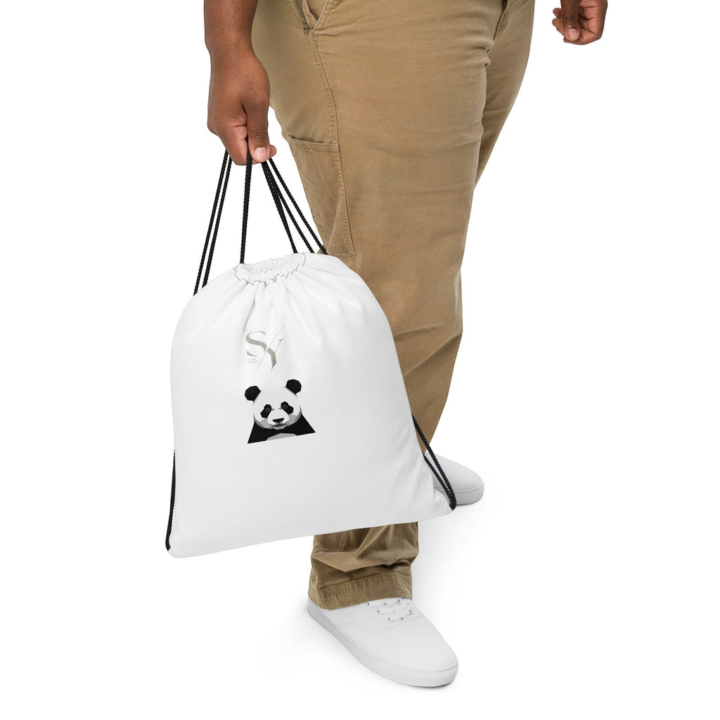 Stylio white polyester drawstring bag with a black panda graphic and drawstring closure, worn by a person.