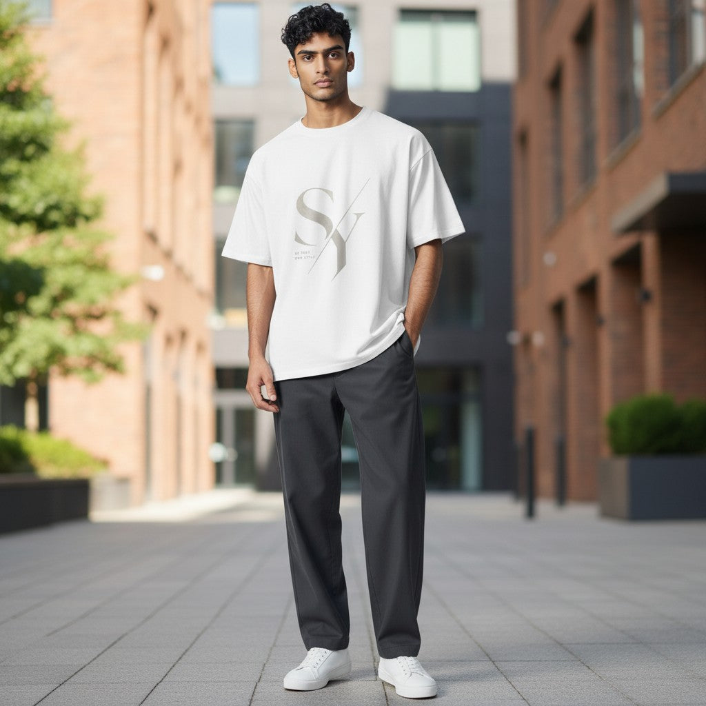 Stylio x Under Armour white short-sleeve t-shirt with grey 'SY' graphic and 'Be Your Own Style' text. Made from recycled polyester.